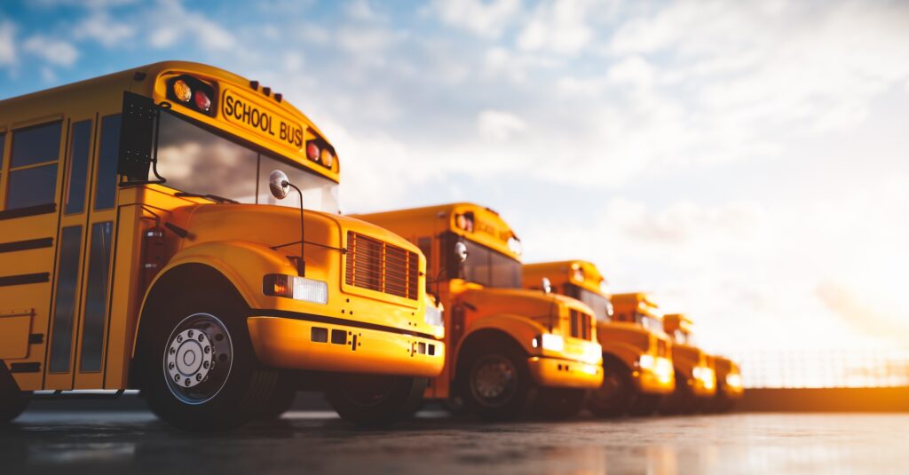 Yellow school bus fleet on parking